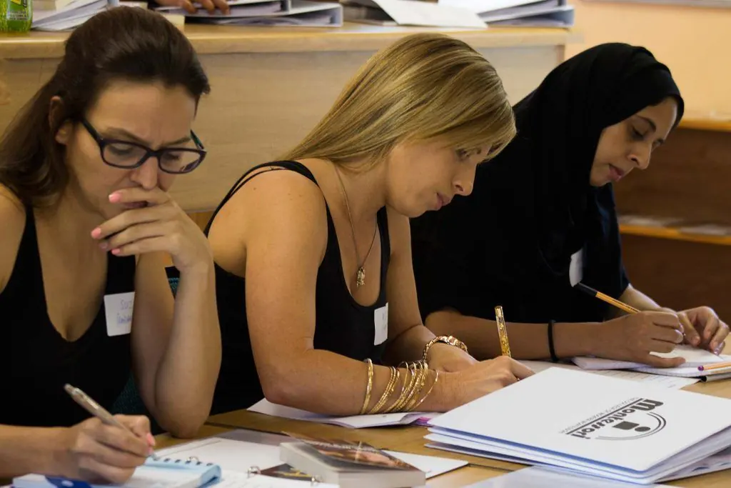 Montessori teacher training students working through course material in class