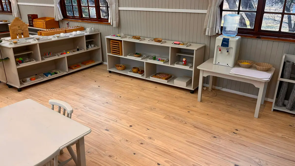 A Montessori classroom with low shelves of materials, child-sized tables and large windows