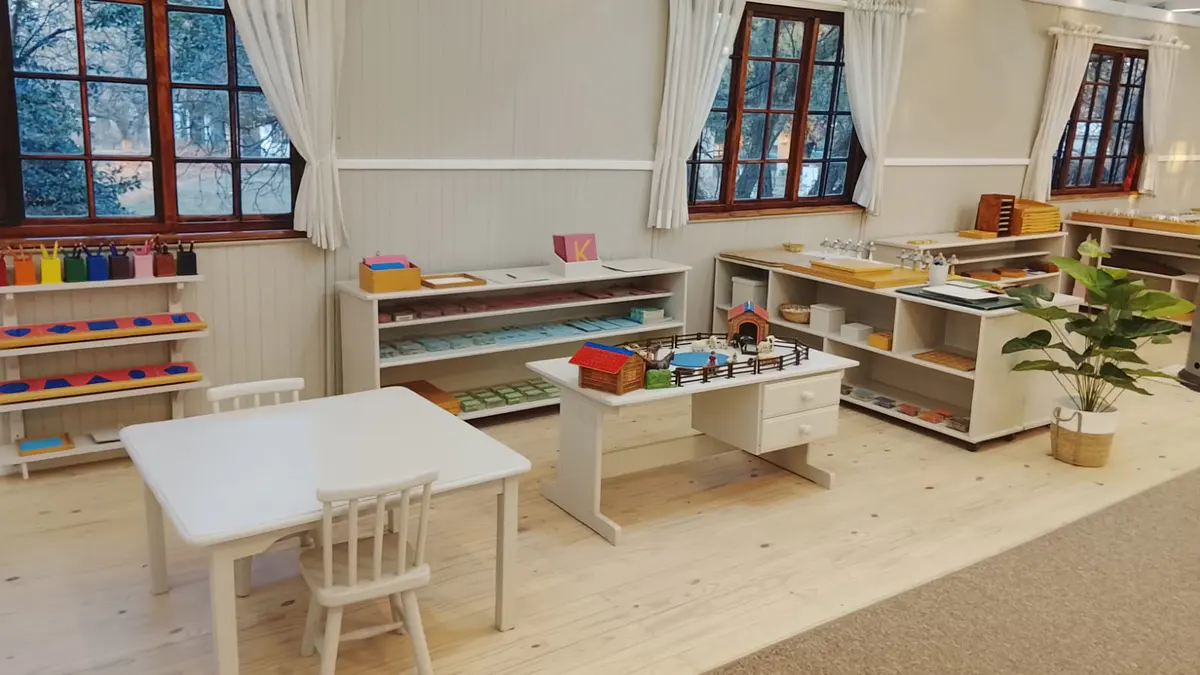 Montessori materials arranged in order on open low shelving