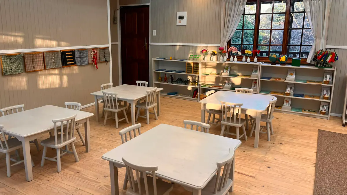 A Montessori classroom with child-sized tables, low shelves and materials in order